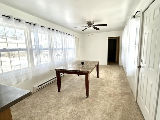 interior space with light carpet, baseboard heating, and ceiling fan