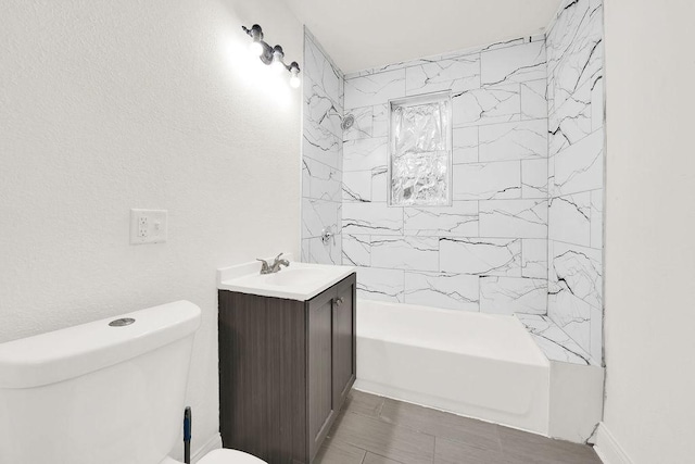 full bathroom with tiled shower / bath combo, vanity, and toilet