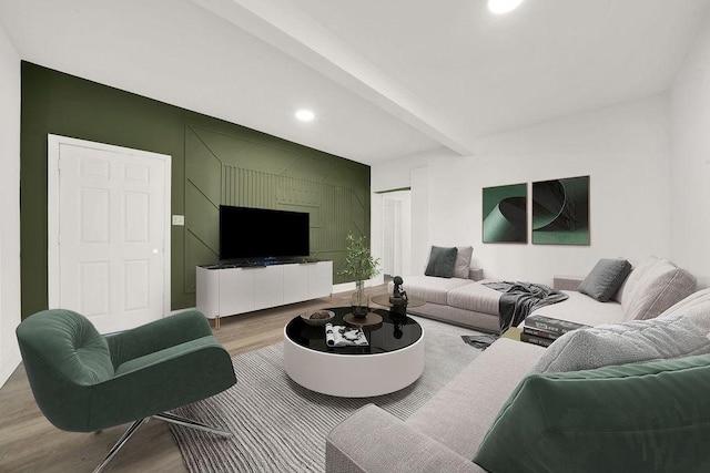 living room featuring beamed ceiling and wood-type flooring