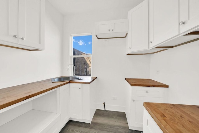 laundry room featuring sink and dark wood-type flooring