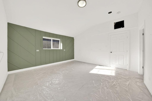 empty room featuring vaulted ceiling