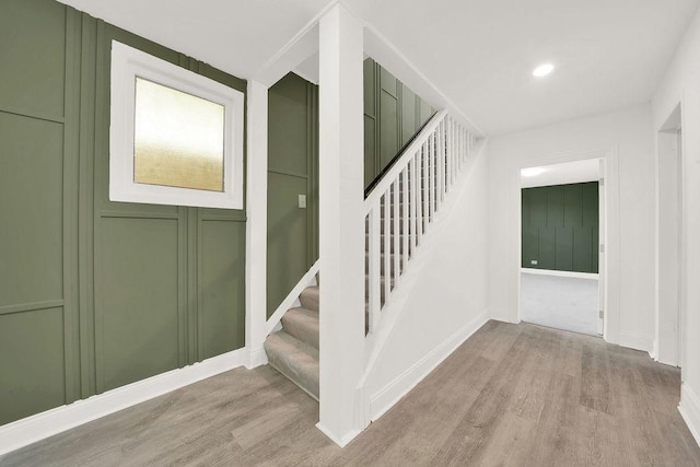 stairs featuring wood-type flooring