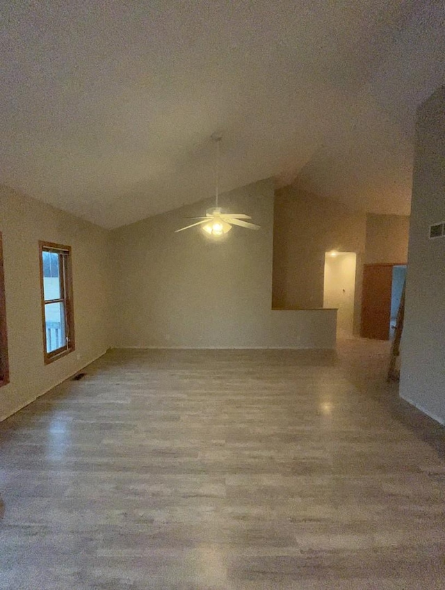 interior space with ceiling fan and vaulted ceiling