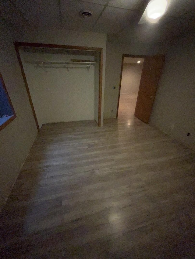 unfurnished bedroom with wood-type flooring and a closet