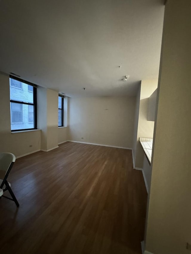 unfurnished living room featuring dark hardwood / wood-style flooring