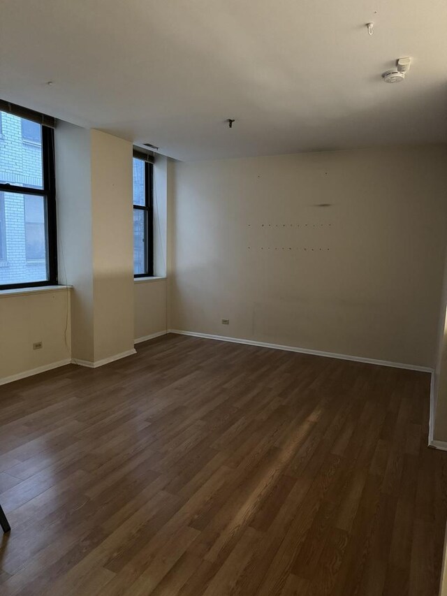 unfurnished room featuring dark hardwood / wood-style flooring