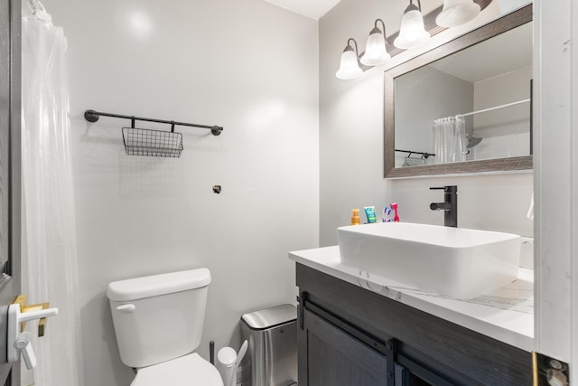 bathroom featuring vanity, toilet, and walk in shower