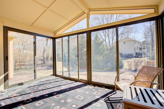 sunroom / solarium with lofted ceiling with beams