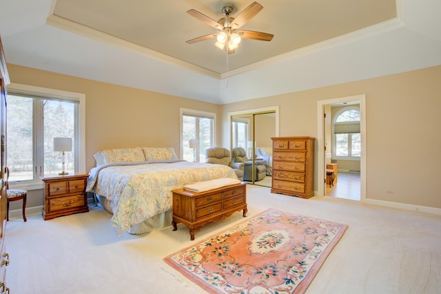 bedroom with a raised ceiling and multiple windows