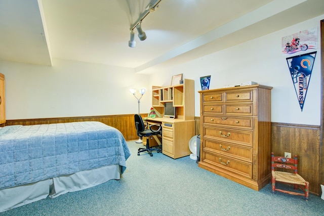 bedroom featuring a wainscoted wall, carpet, and wooden walls