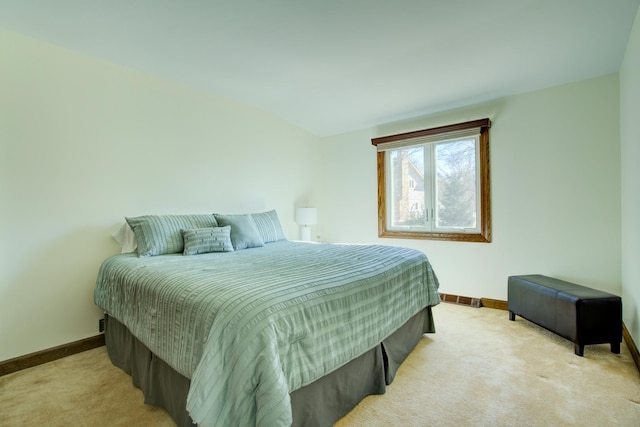 bedroom featuring light carpet, visible vents, and baseboards