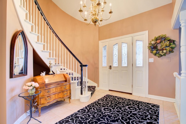 tiled entryway featuring a chandelier, stairs, and baseboards