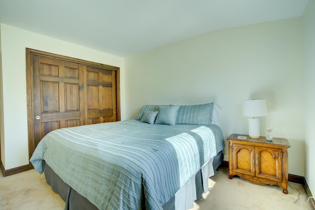 bedroom featuring baseboards and light carpet