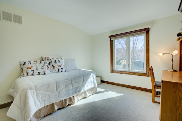 bedroom featuring visible vents, lofted ceiling, baseboards, and carpet floors