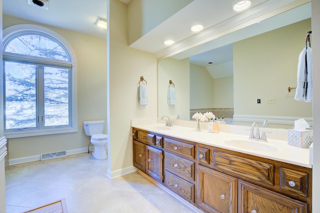 bathroom featuring a sink, visible vents, toilet, and a healthy amount of sunlight