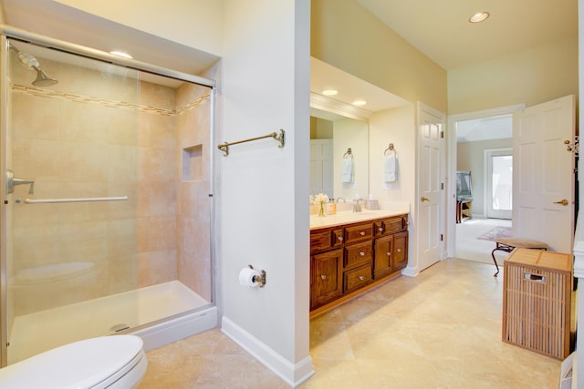 full bathroom with a stall shower, toilet, baseboards, and double vanity