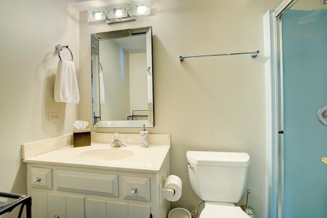 full bathroom featuring an enclosed shower, toilet, and vanity