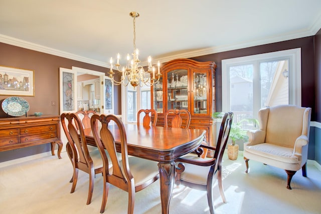 dining room featuring an inviting chandelier, light carpet, and ornamental molding