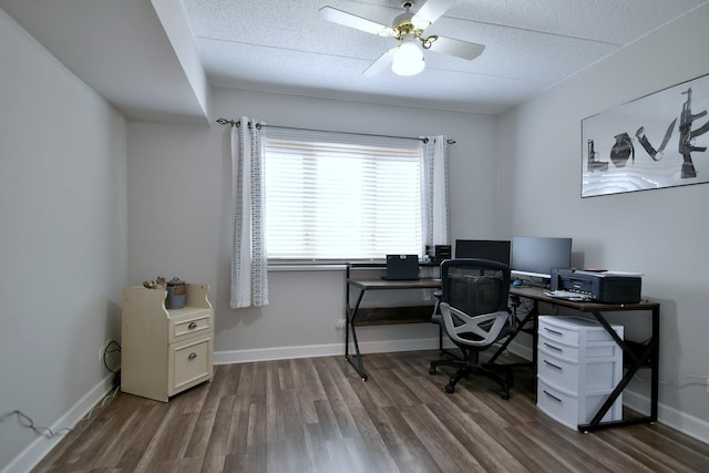 office with dark hardwood / wood-style flooring, a textured ceiling, and ceiling fan