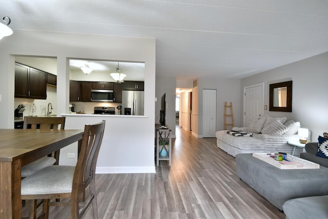 living room with sink and light hardwood / wood-style flooring