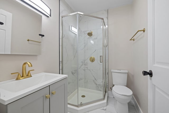 bathroom with toilet, vanity, and a shower with shower door