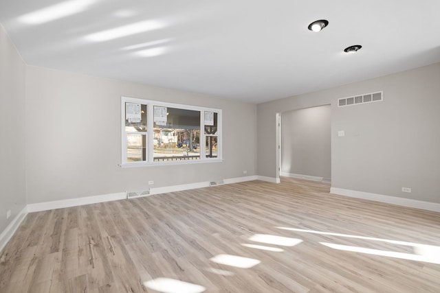 empty room with light hardwood / wood-style floors