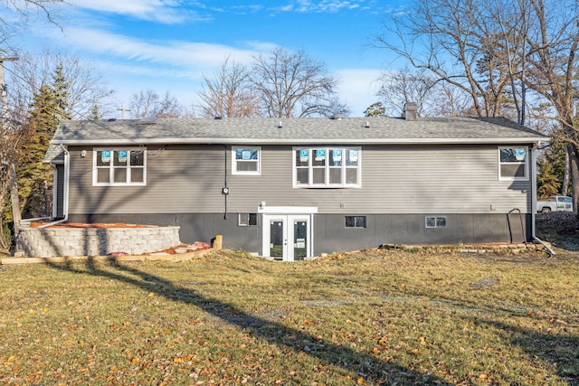 rear view of house featuring french doors and a yard