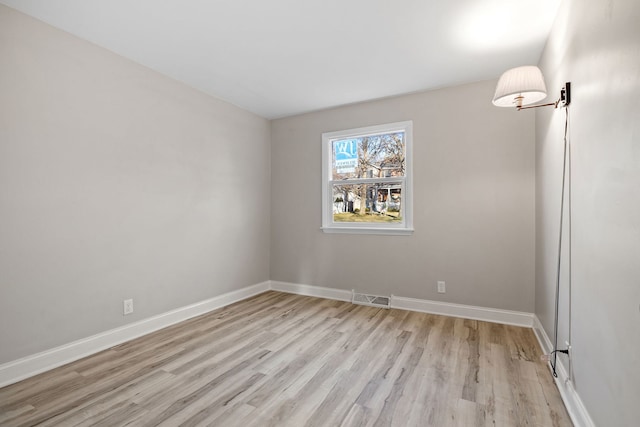 empty room with light hardwood / wood-style flooring