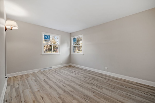 unfurnished room with light wood-type flooring