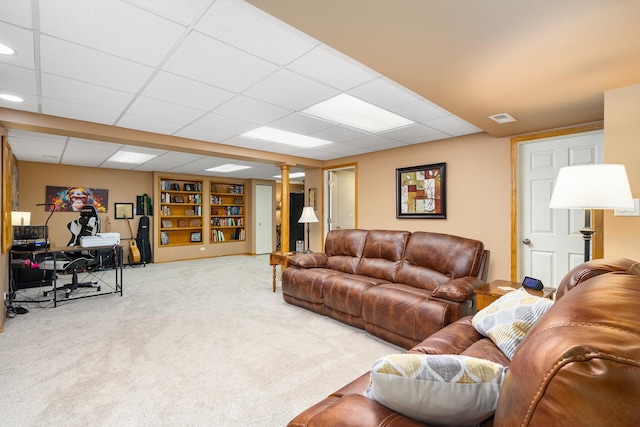 living room with carpet and a drop ceiling