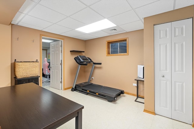 workout room featuring a drop ceiling