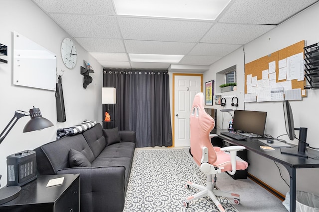 carpeted office with a paneled ceiling