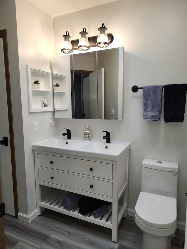 bathroom featuring hardwood / wood-style flooring, vanity, and toilet