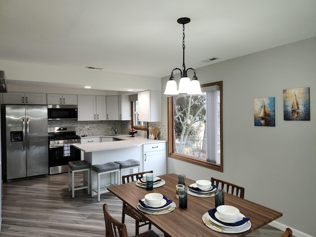 dining room with dark hardwood / wood-style floors and sink