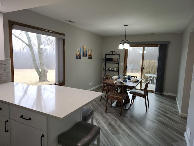 dining space featuring a chandelier and light hardwood / wood-style floors