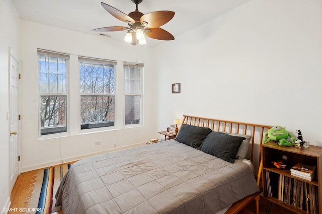 bedroom with ceiling fan and wood-type flooring