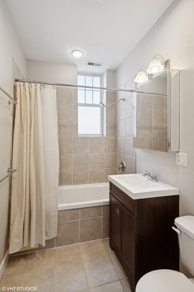 full bathroom featuring toilet, tile patterned floors, shower / tub combo with curtain, and vanity