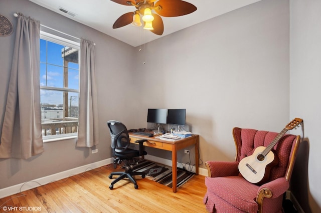 office with ceiling fan and hardwood / wood-style floors