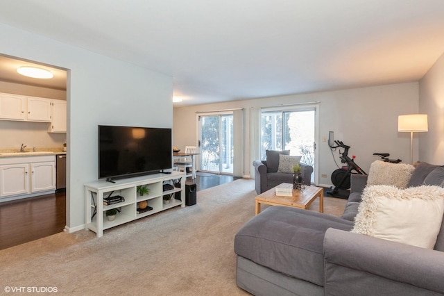 living room featuring baseboards and light colored carpet