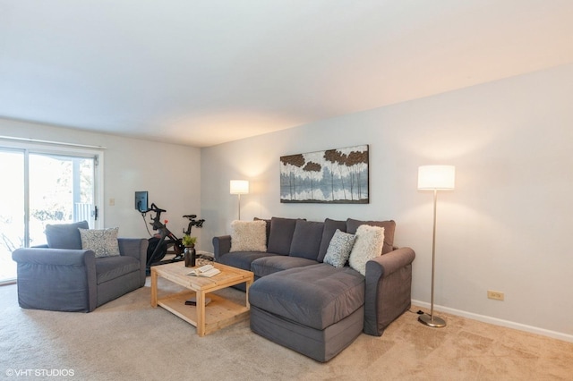 living room with light carpet and baseboards