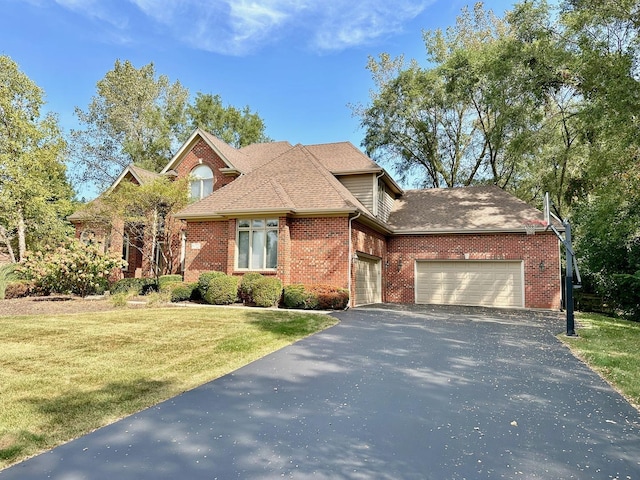 view of front of home with a front yard and a garage