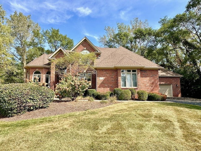 view of front facade with a garage and a front lawn