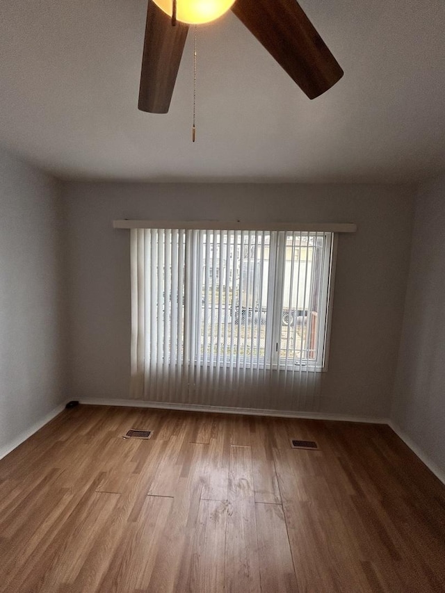 empty room featuring ceiling fan and wood-type flooring