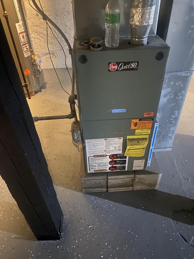 utility room with gas water heater and heating unit