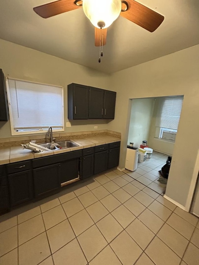 kitchen with sink and light tile patterned flooring