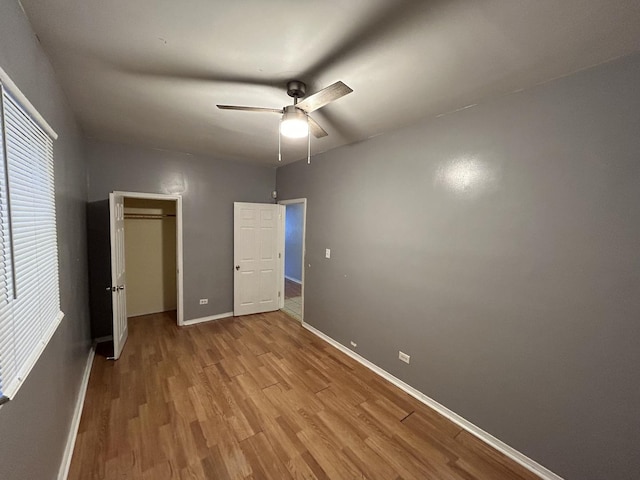 unfurnished bedroom with ceiling fan and light wood-type flooring