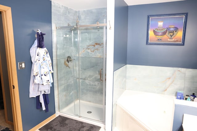 bathroom featuring shower with separate bathtub