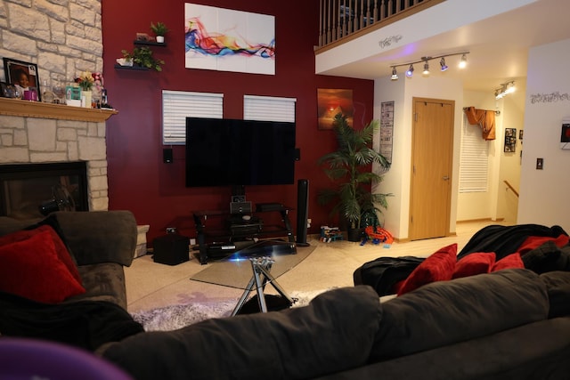 carpeted living room featuring a stone fireplace