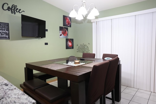 tiled dining area featuring a notable chandelier