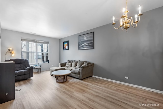 living room featuring a chandelier and wood-type flooring